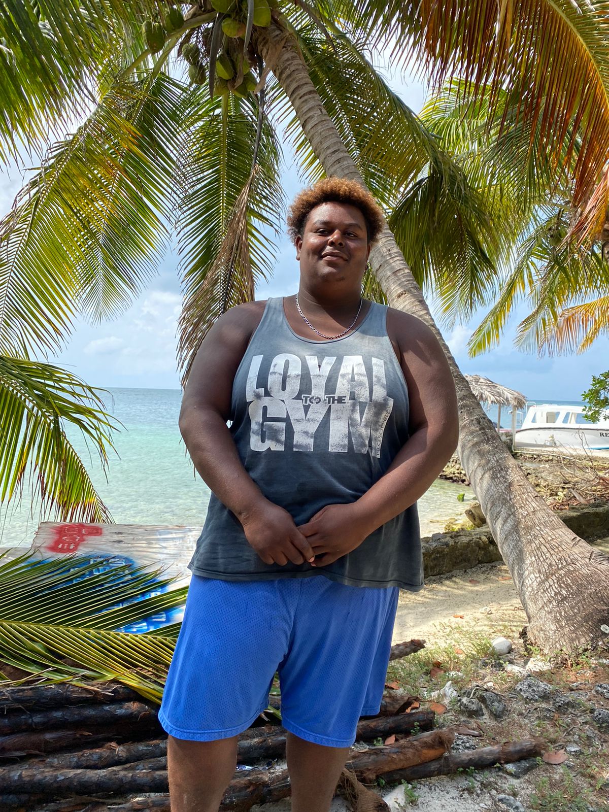 a person standing in front of a palm tree