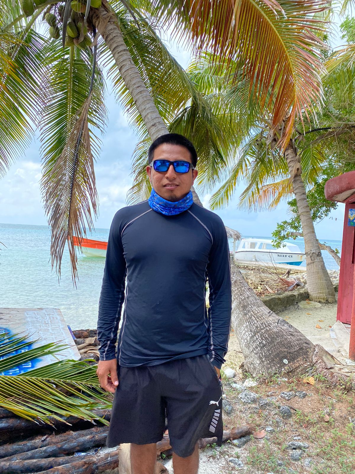 a man standing in front of a tree posing for the camera